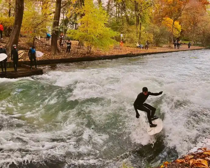 A man riding a wave on top of a surfboard