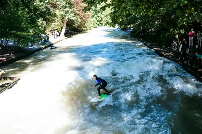 a man riding a wave on top of a surfboard